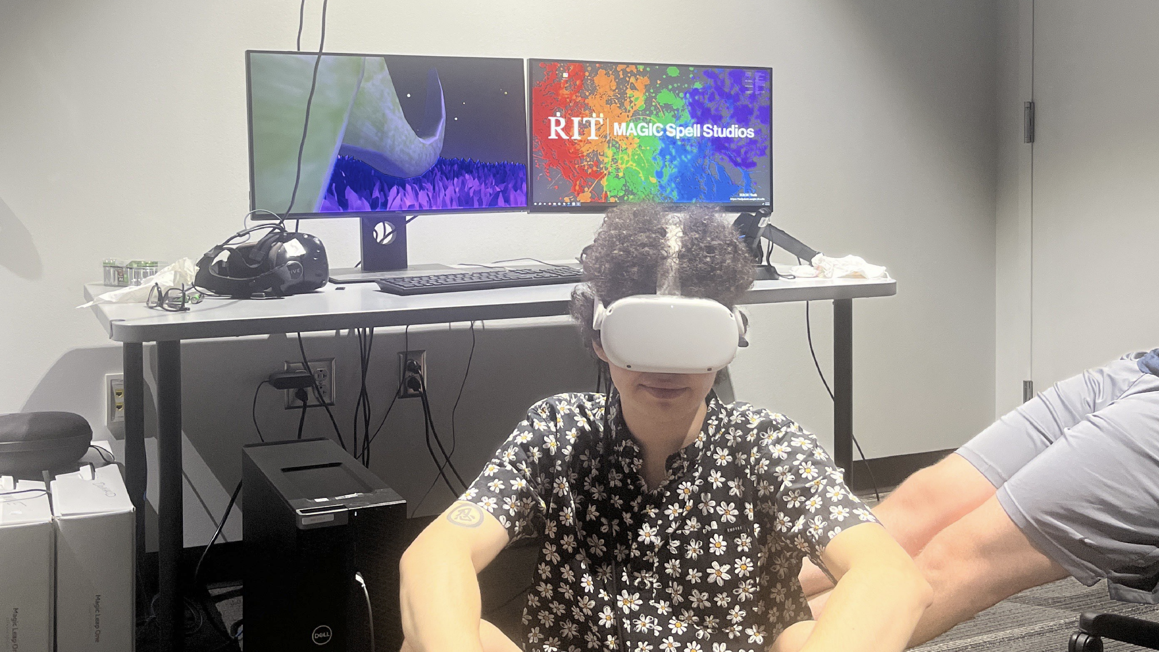 Changeling developer sitting on the ground in Mind Palace level's grass while in VR